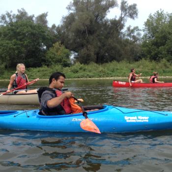 a person in a blue kayak in the water