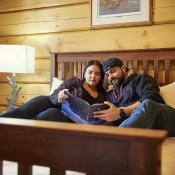 two people laying in a bed