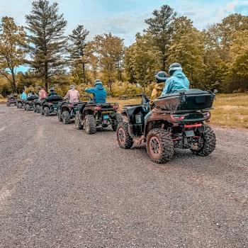 a group of people on atvs driving a trail