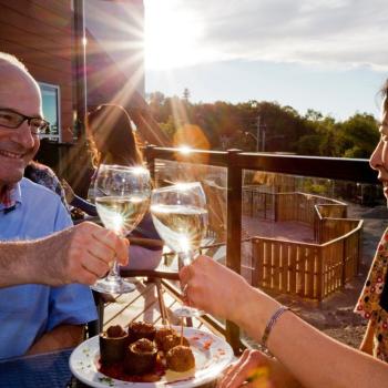 two people dining with wine glasses in their hands