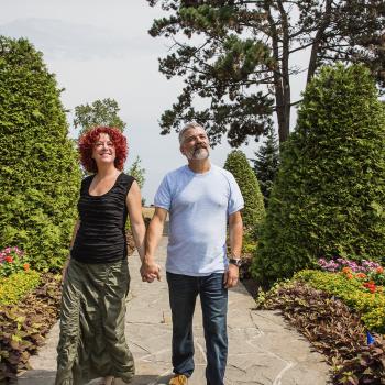 a couple walking through a garden