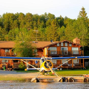 Float plane in front of lodge