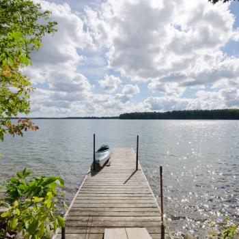 View of lake with dock and kayak