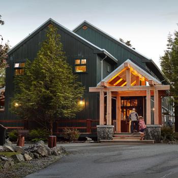 two people walking into large lodge resort