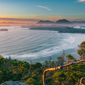 Cox Bay Lookout at sunset, with calm blue waves and turquoise sky