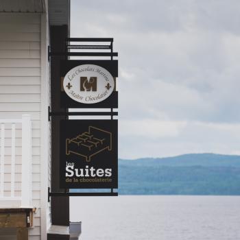 Chocolate and accommodation signs on building