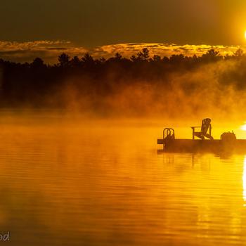 Dock on lake at sunrise