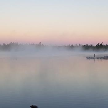 Lake view at sunrise with fog