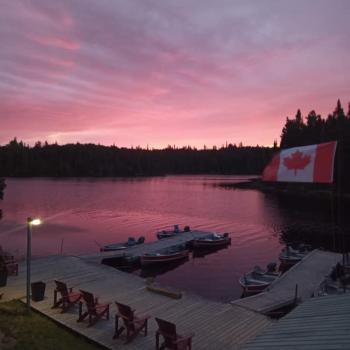 Dock on lake at sunset