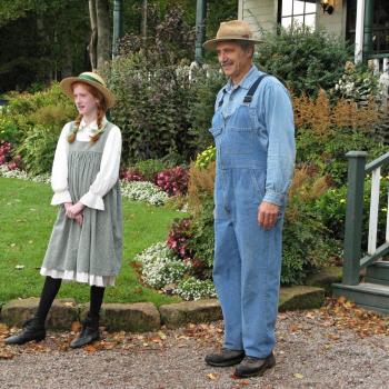 two statues in front of a porch