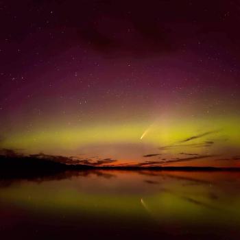 Shooting star over water at night.