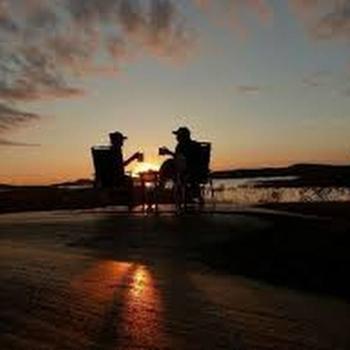 Two people enjoying the sunset.