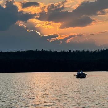 Fishing on a lake at sunrise