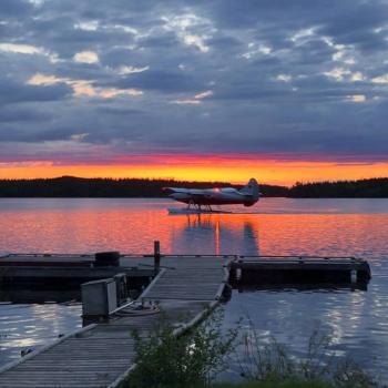 Airplane on lake at sunset