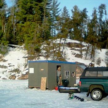 Ice fishing hut on frozen lake